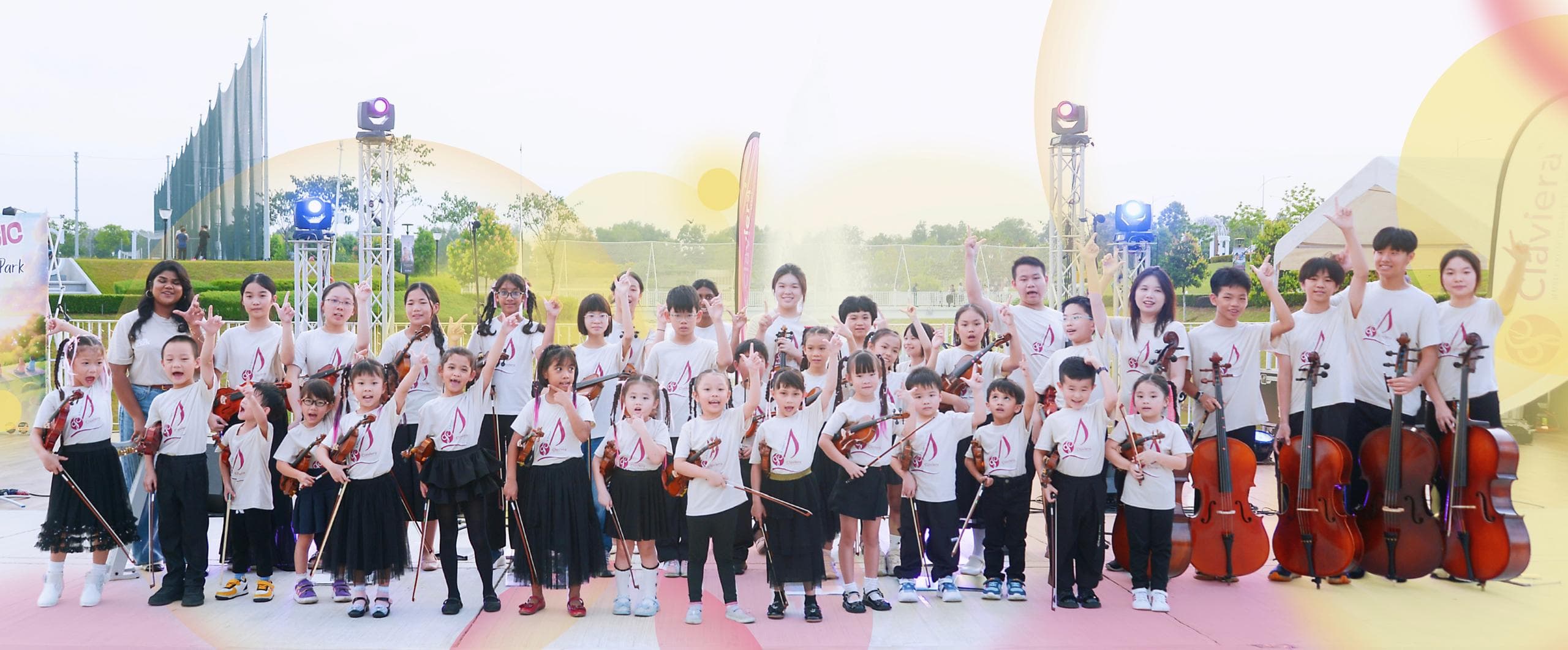 Claviera’s young string musicians gathered with violins and cellos at an outdoor event.