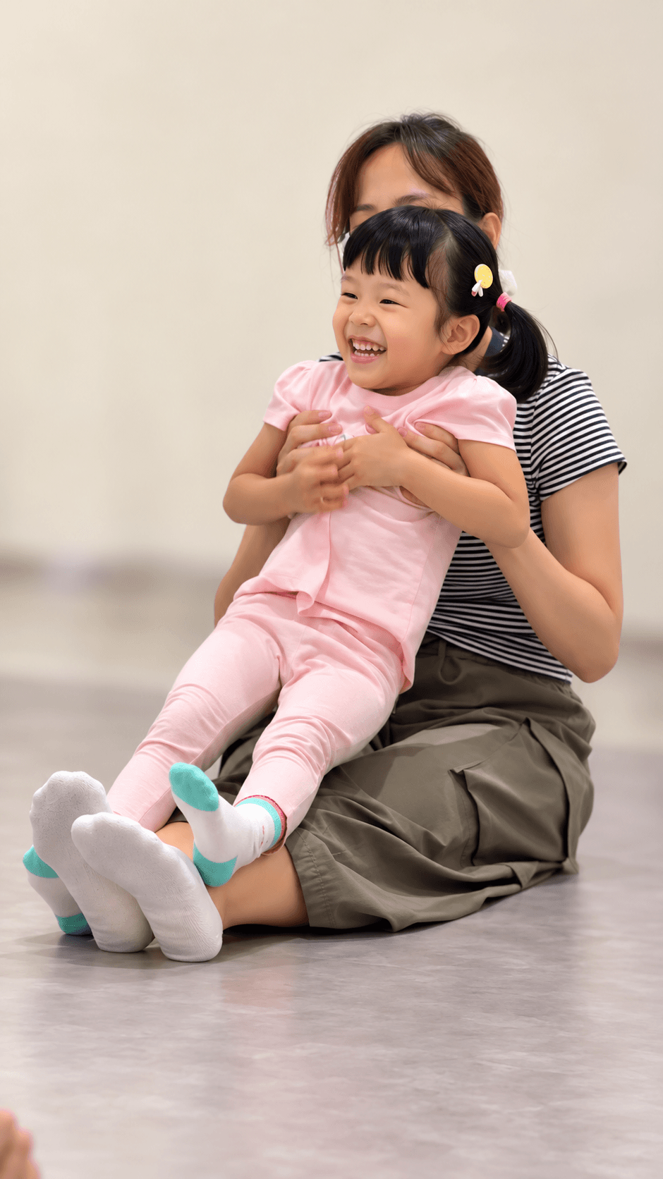A parent holding and comforting a young child during a Claviera Petite session.